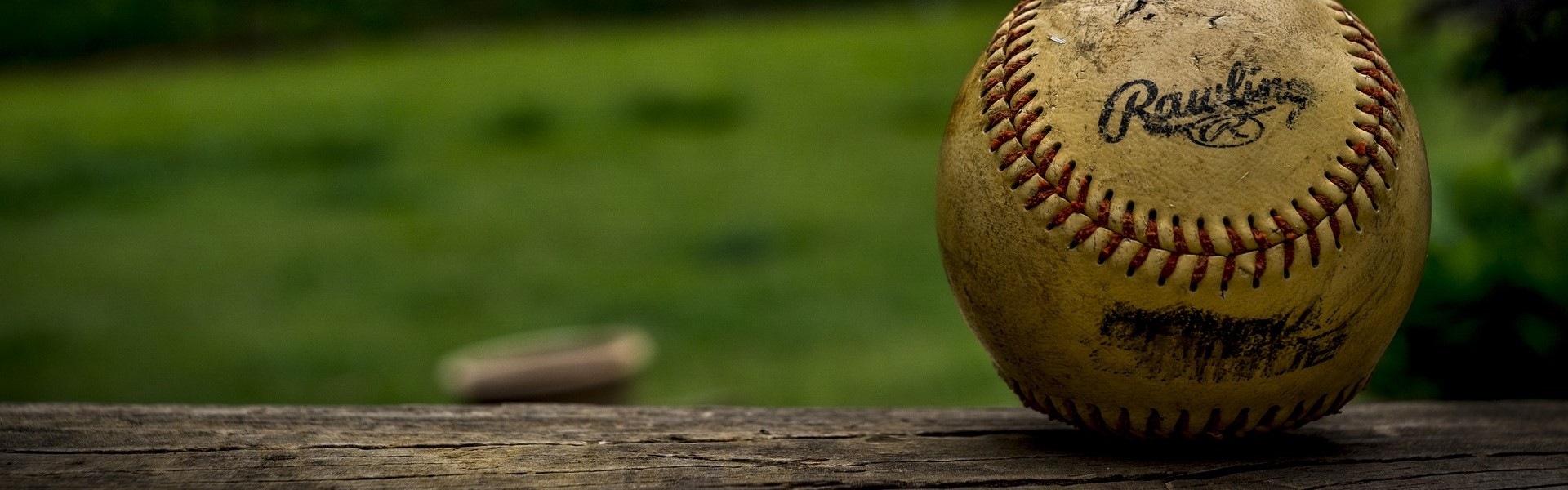 baseball on wooden railing